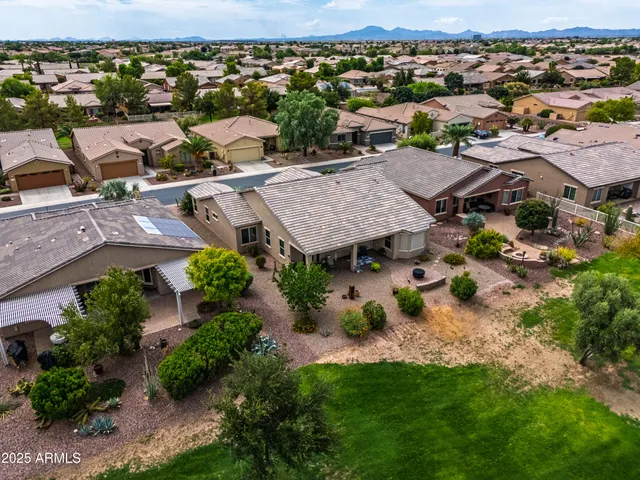 an aerial view of residential houses with outdoor space