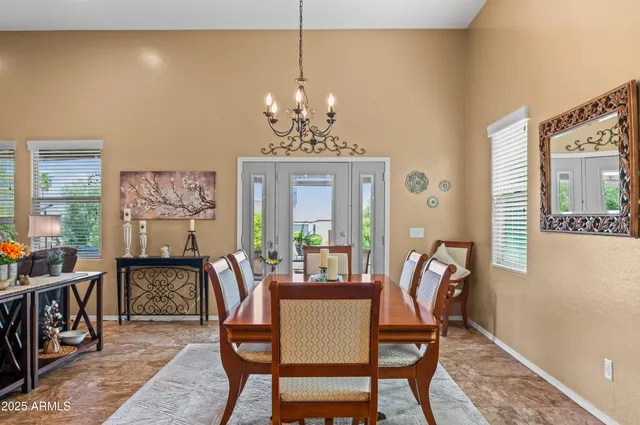 a dining room with furniture a rug and a chandelier