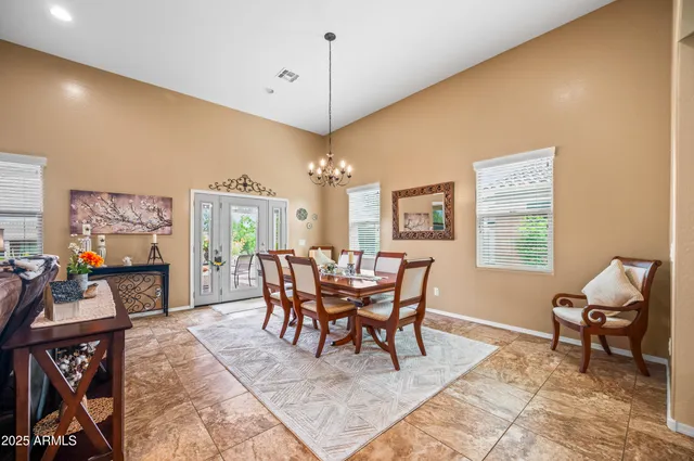a dining room with furniture a rug and a chandelier