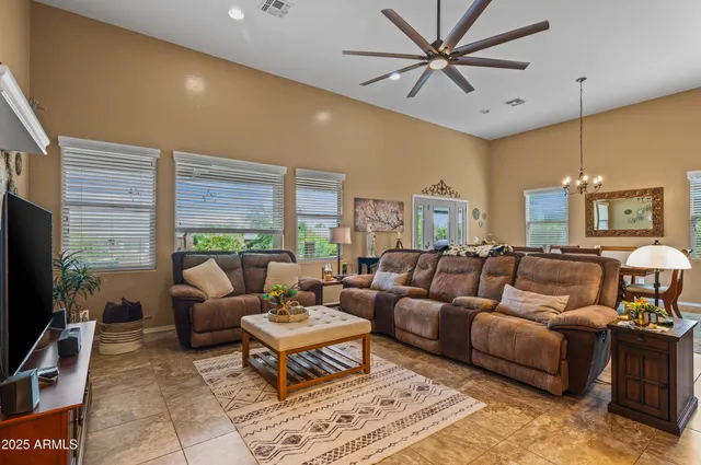a living room with furniture a large window and a flat screen tv