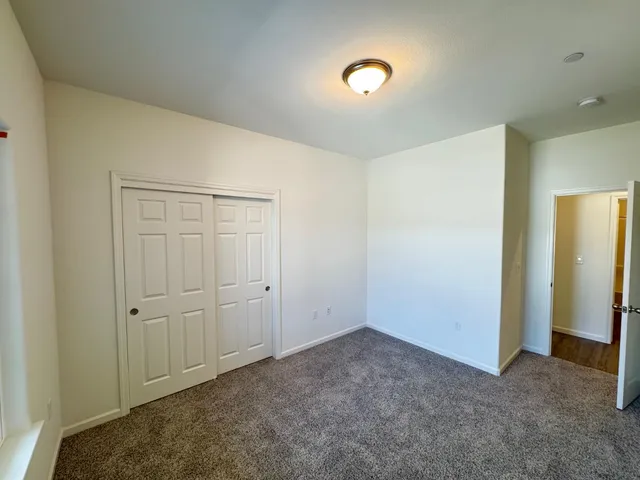 an empty room with closet area