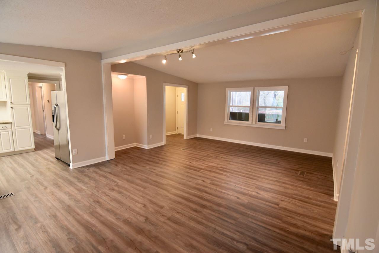 10110 Timothy Road Dunn, NC 28334 - Photo 11 of 41 a view of an empty room with wooden floor and a window