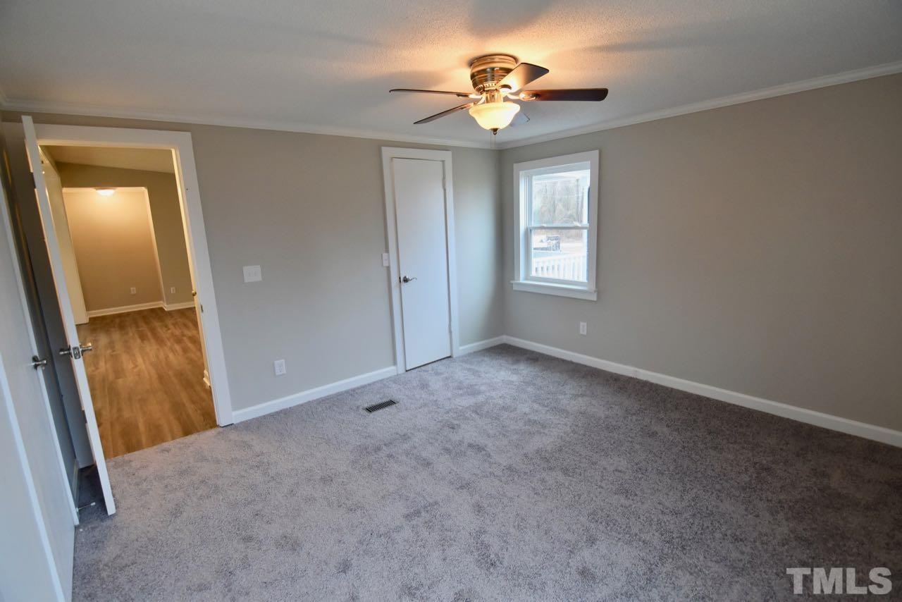 10110 Timothy Road Dunn, NC 28334 - Photo 23 of 41 an empty room with windows and fan