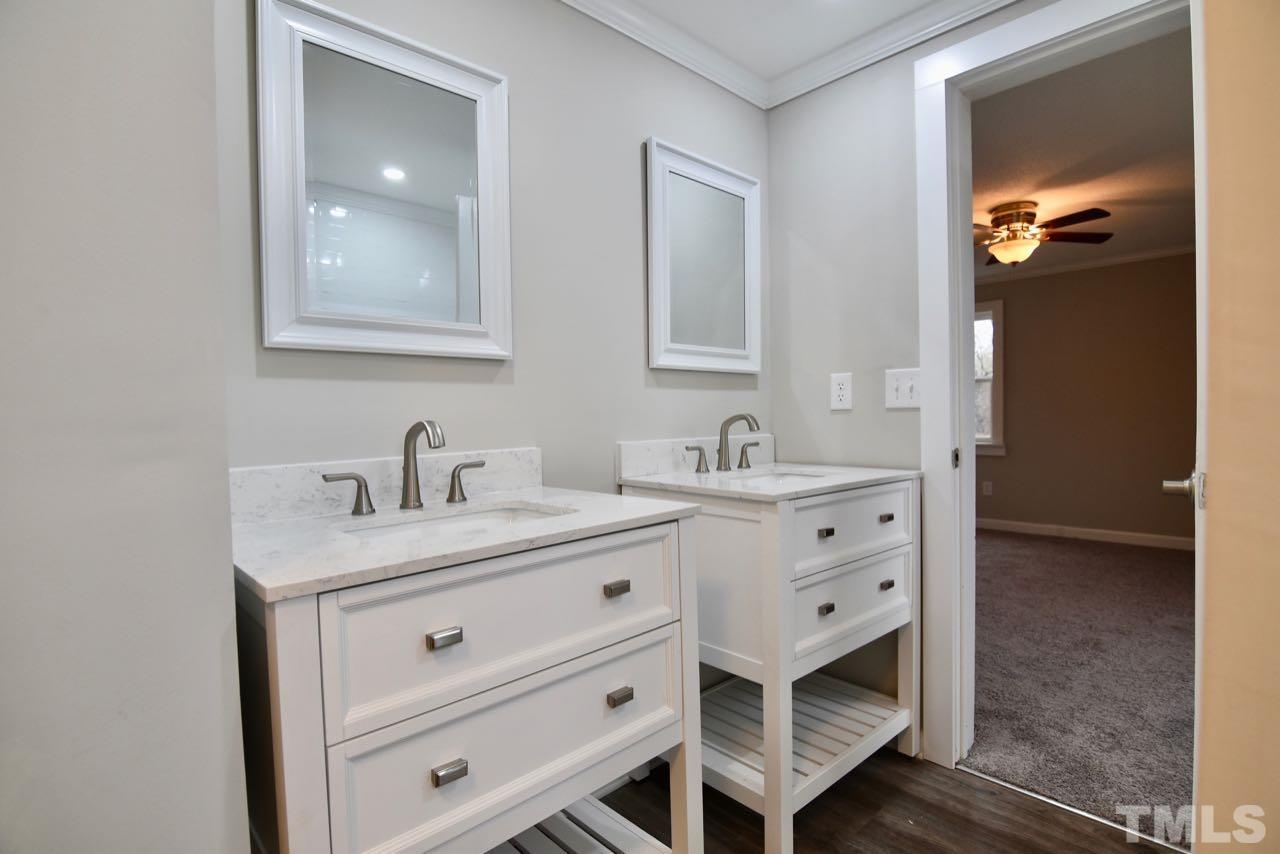 10110 Timothy Road Dunn, NC 28334 - Photo 26 of 41 a bathroom with a sink double vanity and a mirror