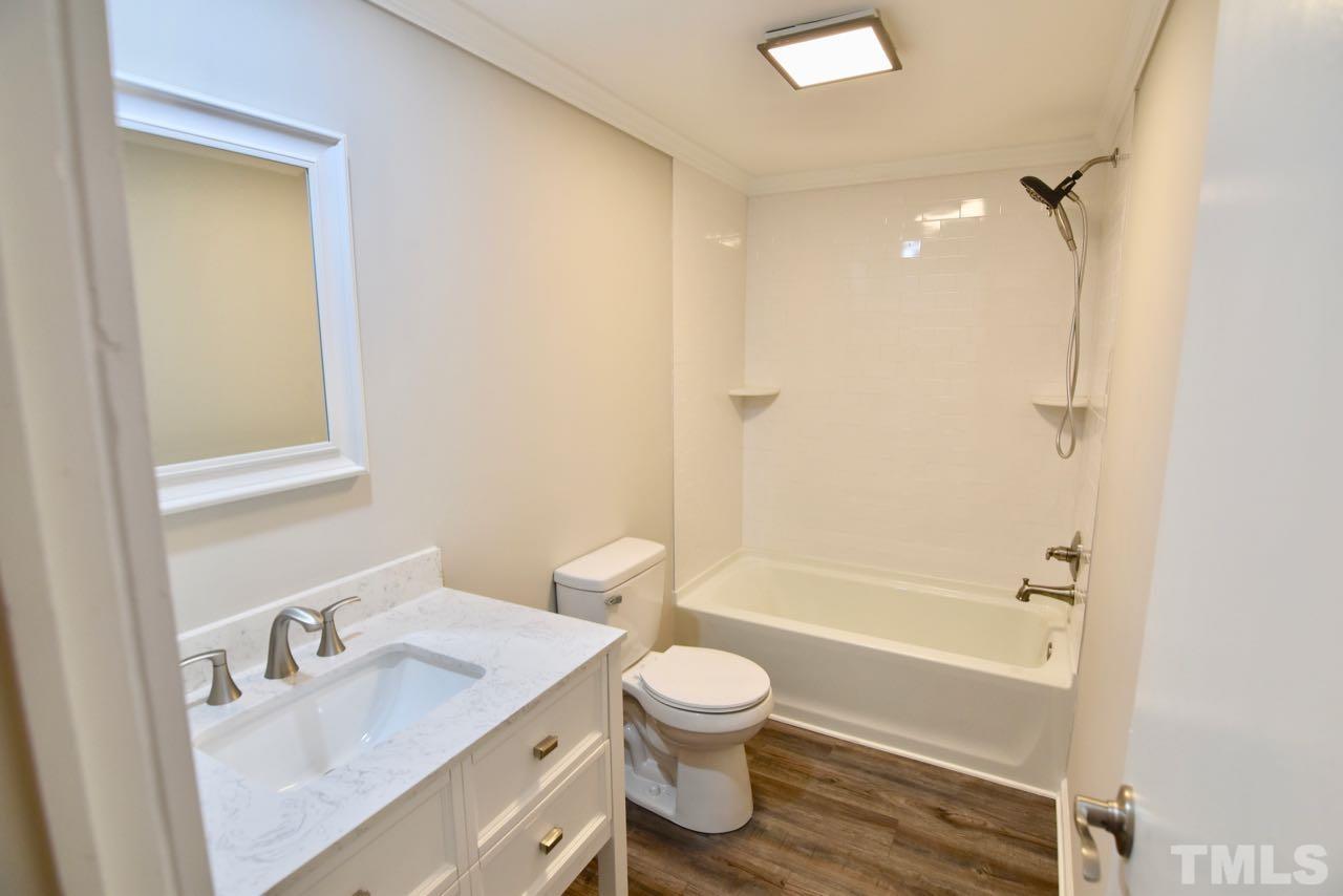 10110 Timothy Road Dunn, NC 28334 - Photo 36 of 41 a bathroom with a sink a toilet and a bathtub