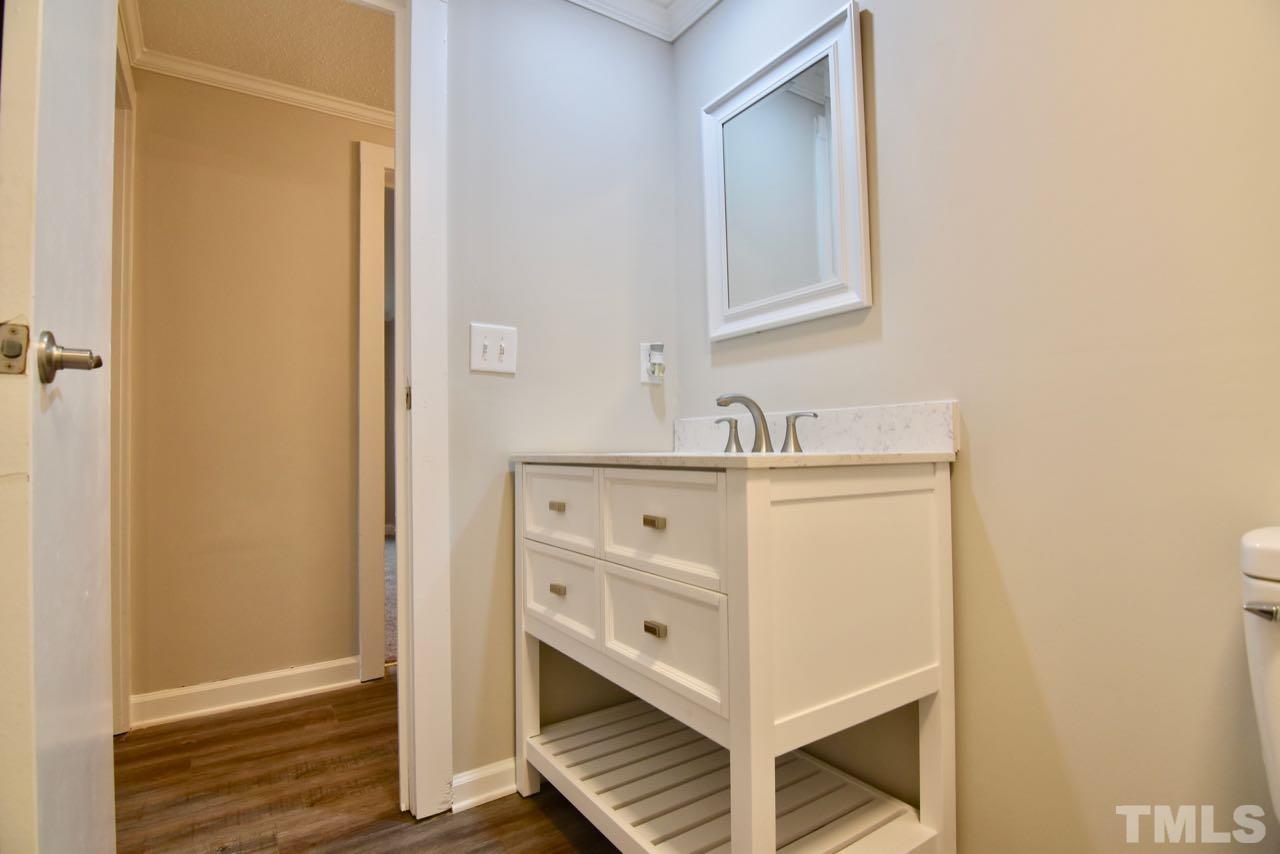 10110 Timothy Road Dunn, NC 28334 - Photo 41 of 41 a bathroom with a sink a mirror and a vanity