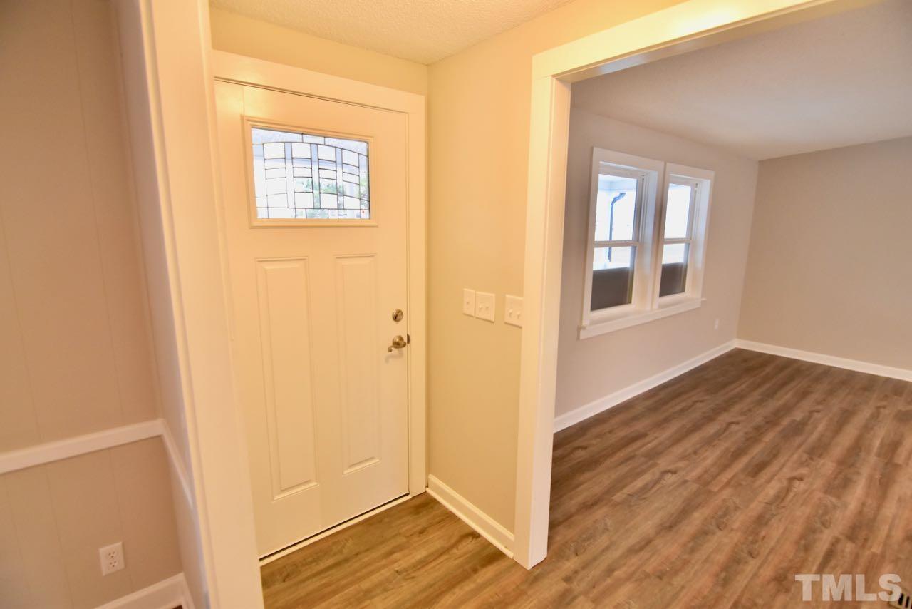 10110 Timothy Road Dunn, NC 28334 - Photo 8 of 41 a view of an empty room with wooden floor and a window