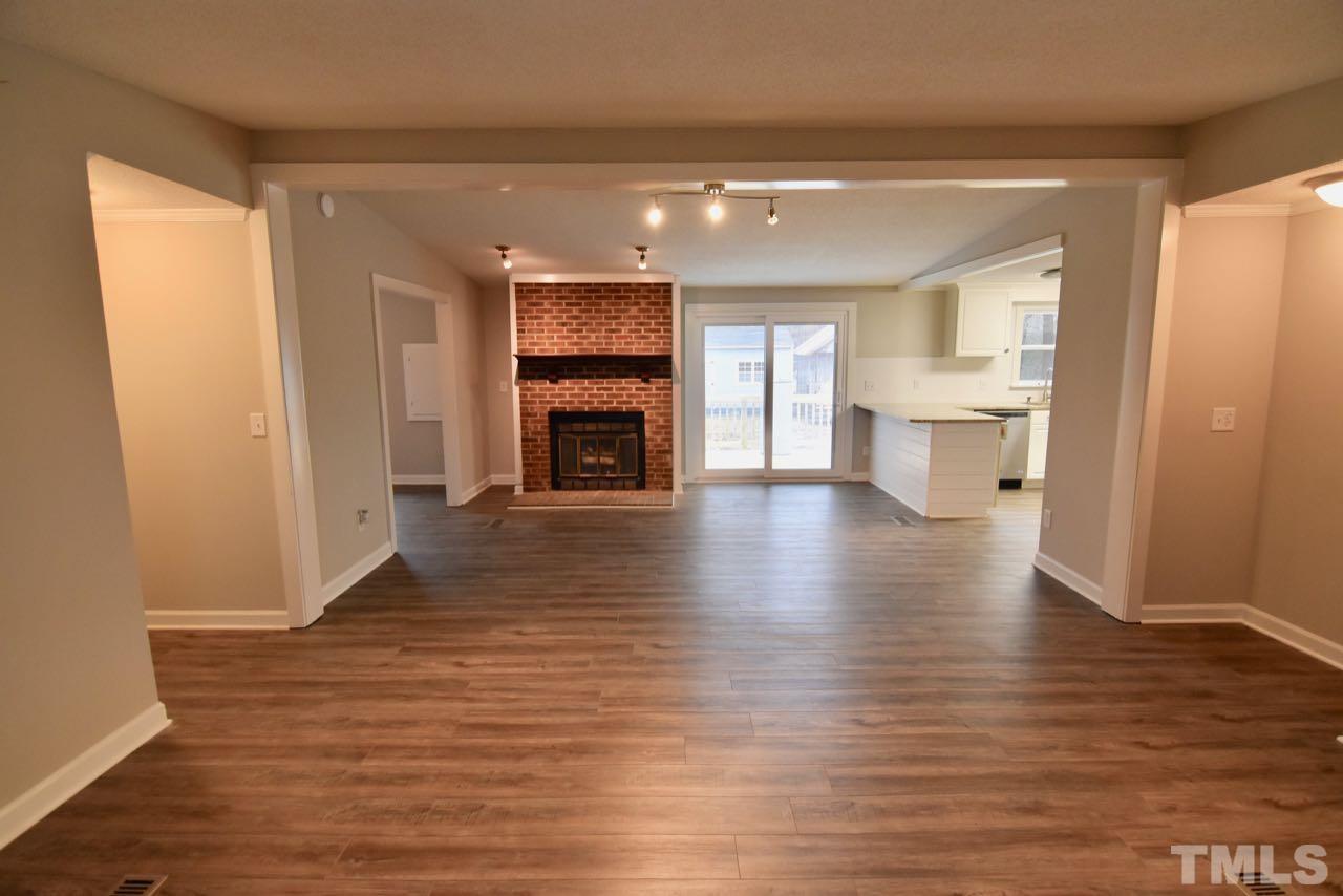 10110 Timothy Road Dunn, NC 28334 - Photo 10 of 41 a view of livingroom with a fireplace wooden floor and a window