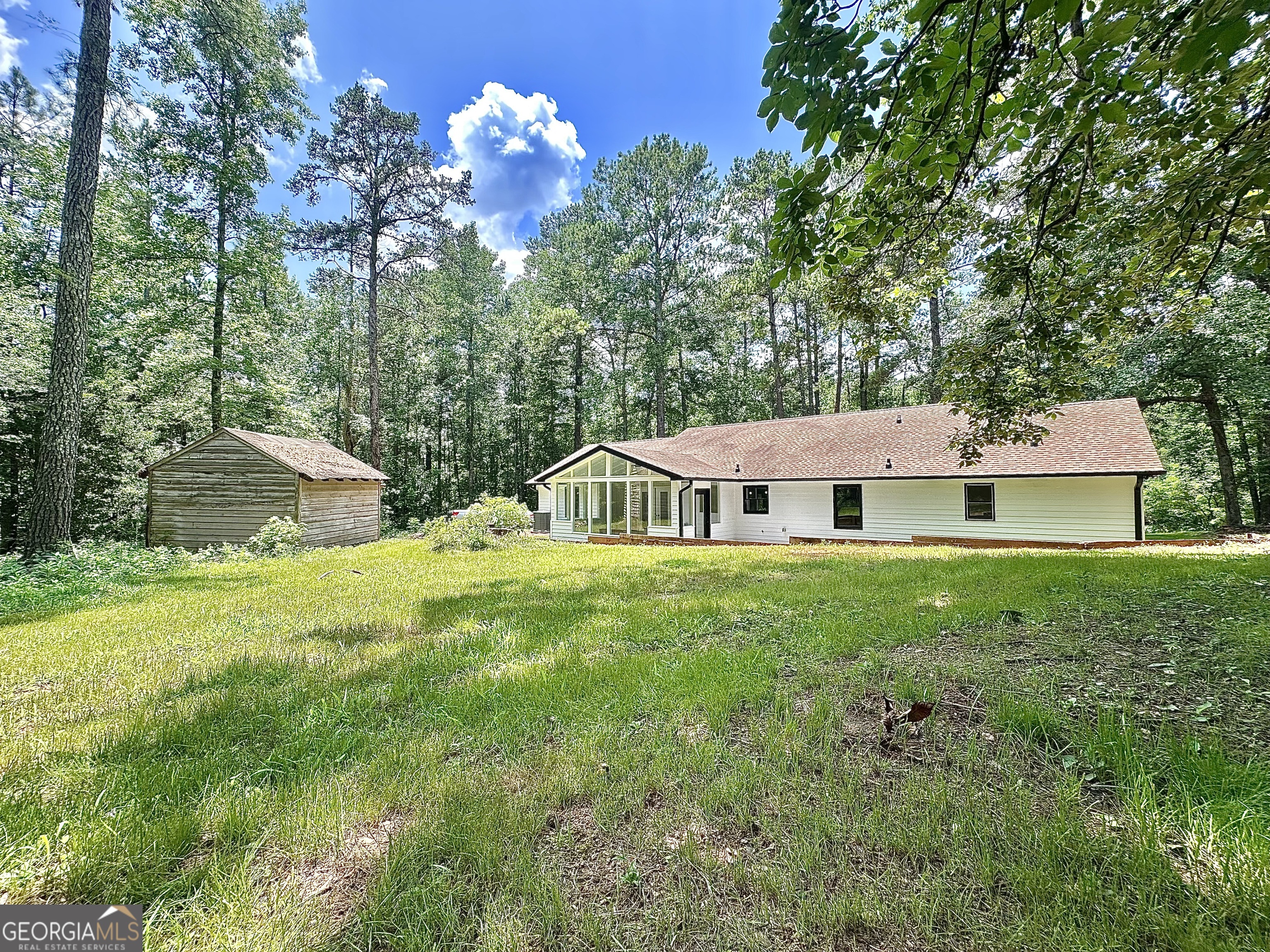 115 Creekside Lane Covington, GA 30016 - Photo 14 of 59 a view of a house with a big yard plants and large trees