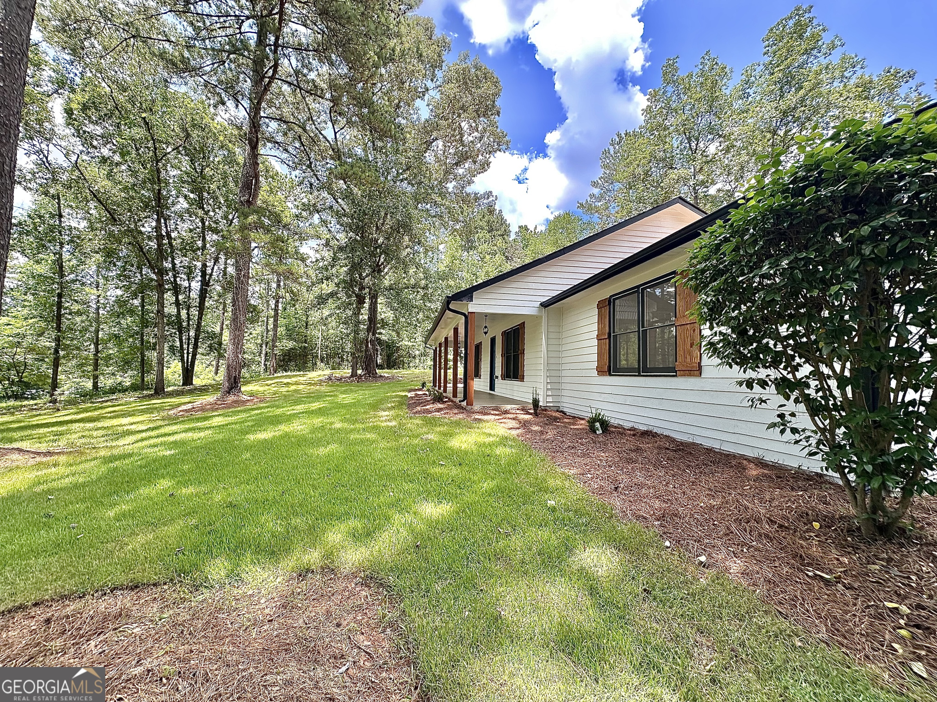 115 Creekside Lane Covington, GA 30016 - Photo 20 of 59 a view of a house with backyard and garden