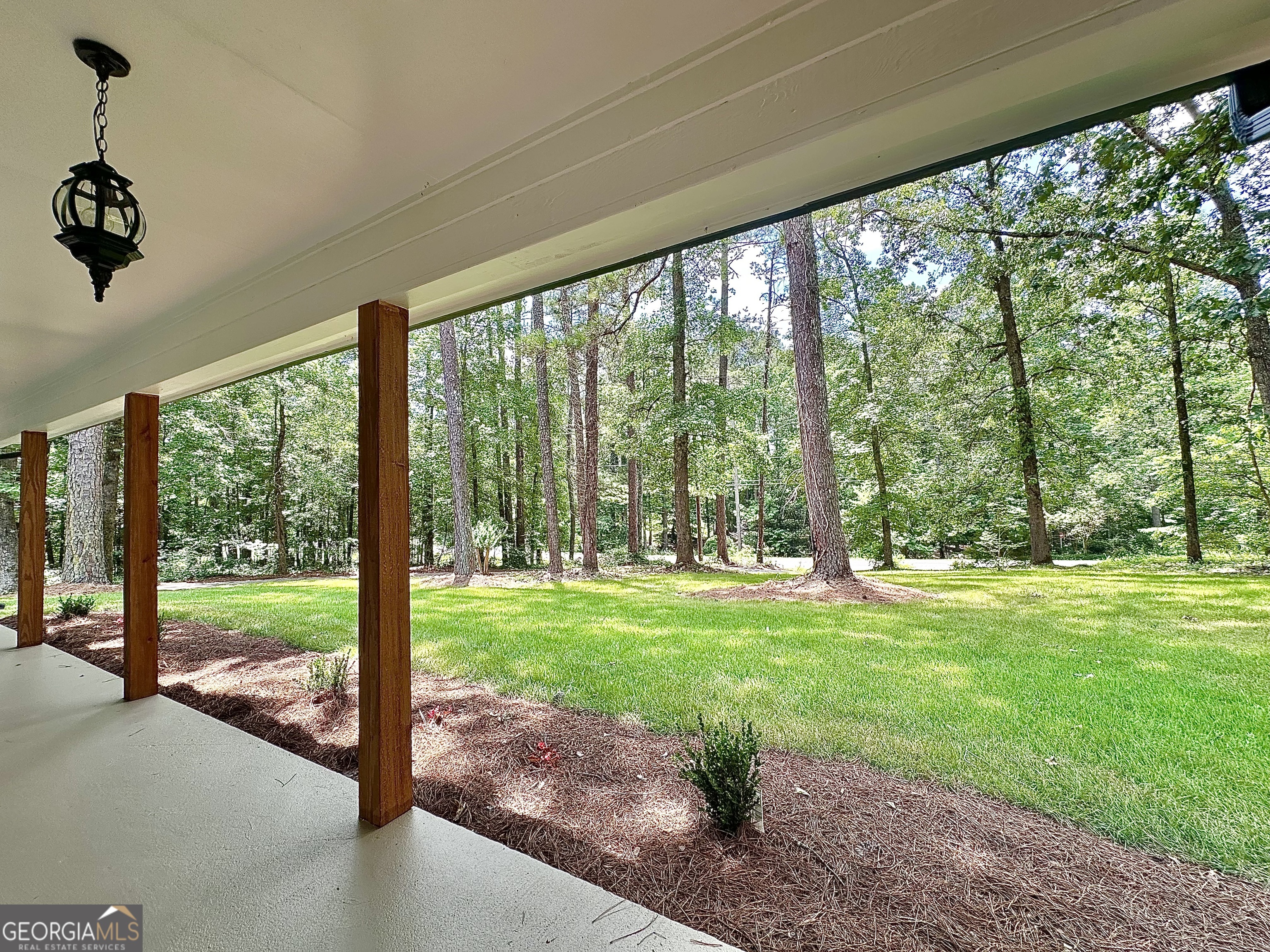 115 Creekside Lane Covington, GA 30016 - Photo 26 of 59 a view of a porch with a garden
