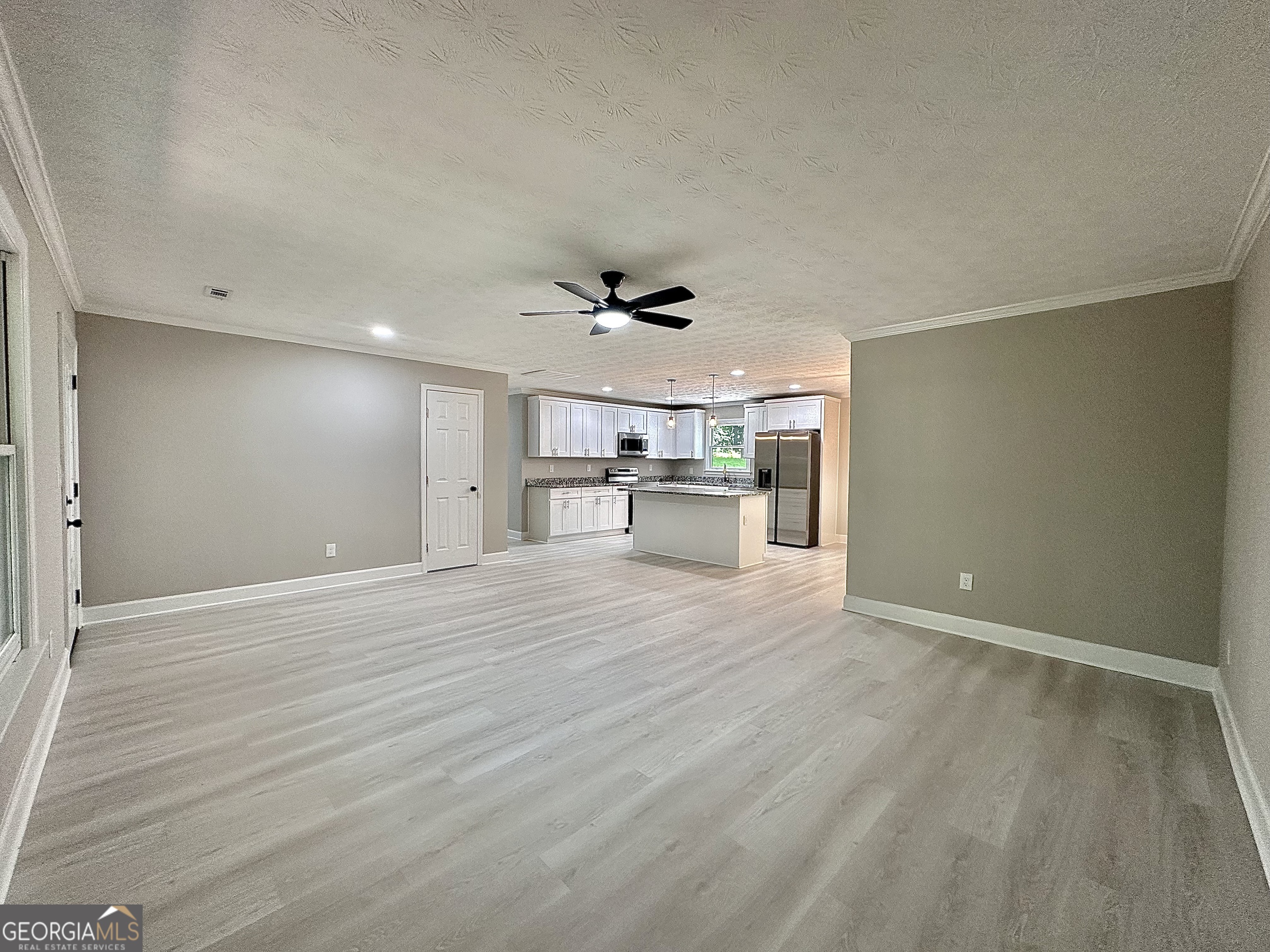 115 Creekside Lane Covington, GA 30016 - Photo 29 of 59 a view of empty room with wooden floor and windows