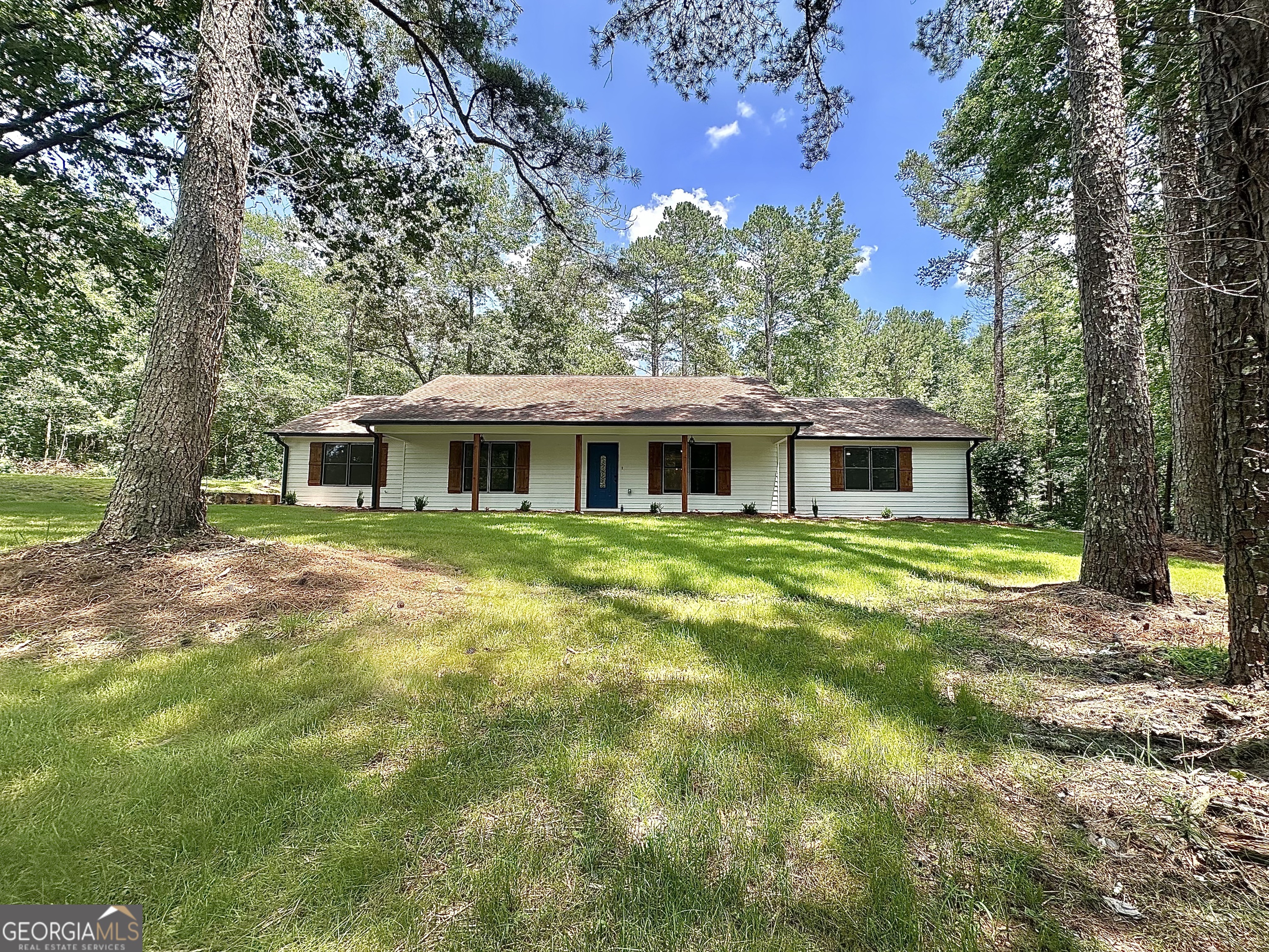 115 Creekside Lane Covington, GA 30016 - Photo 3 of 59 a front view of a house with a yard
