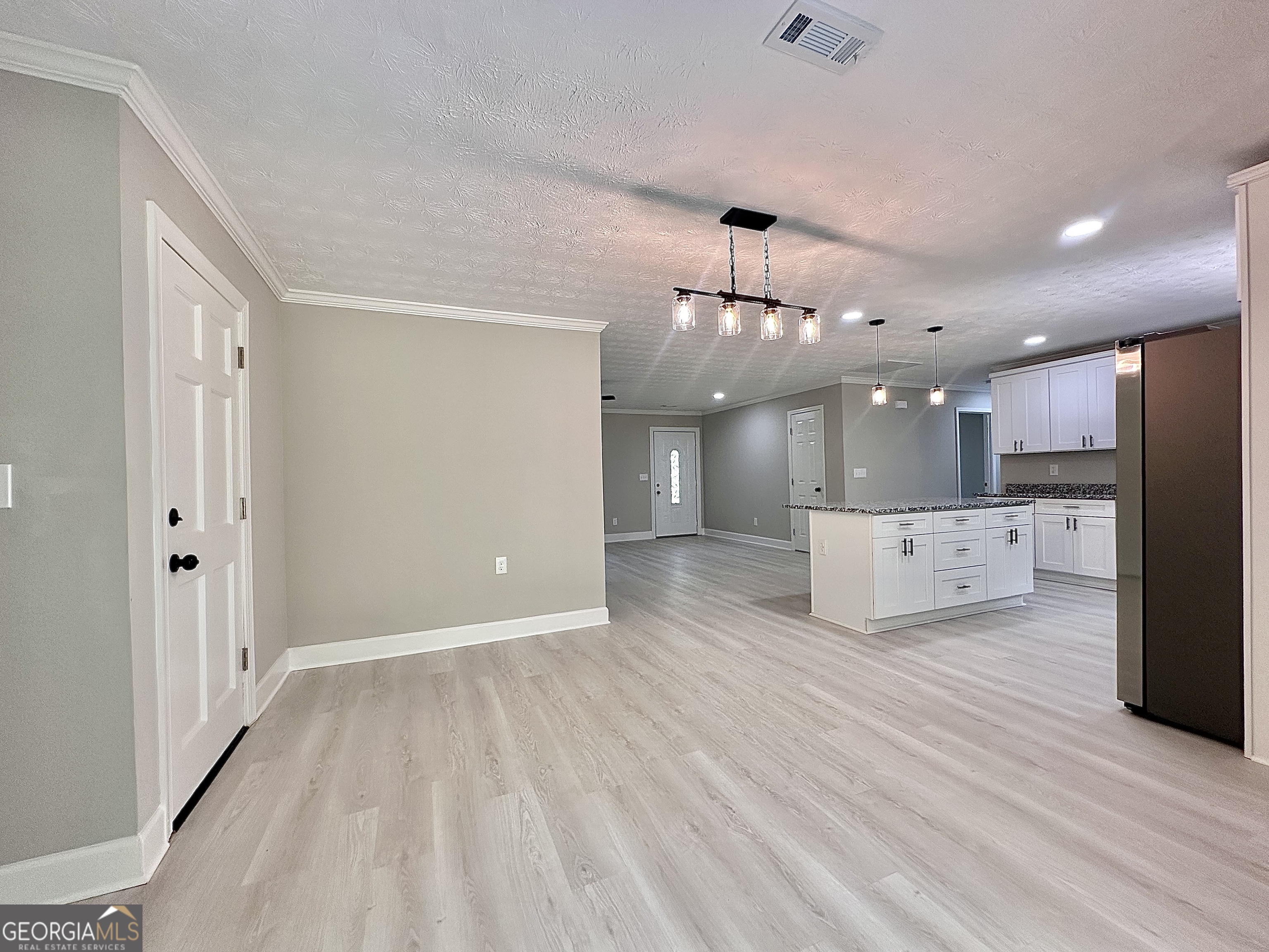 115 Creekside Lane Covington, GA 30016 - Photo 40 of 59 a view of a kitchen with a sink and a refrigerator
