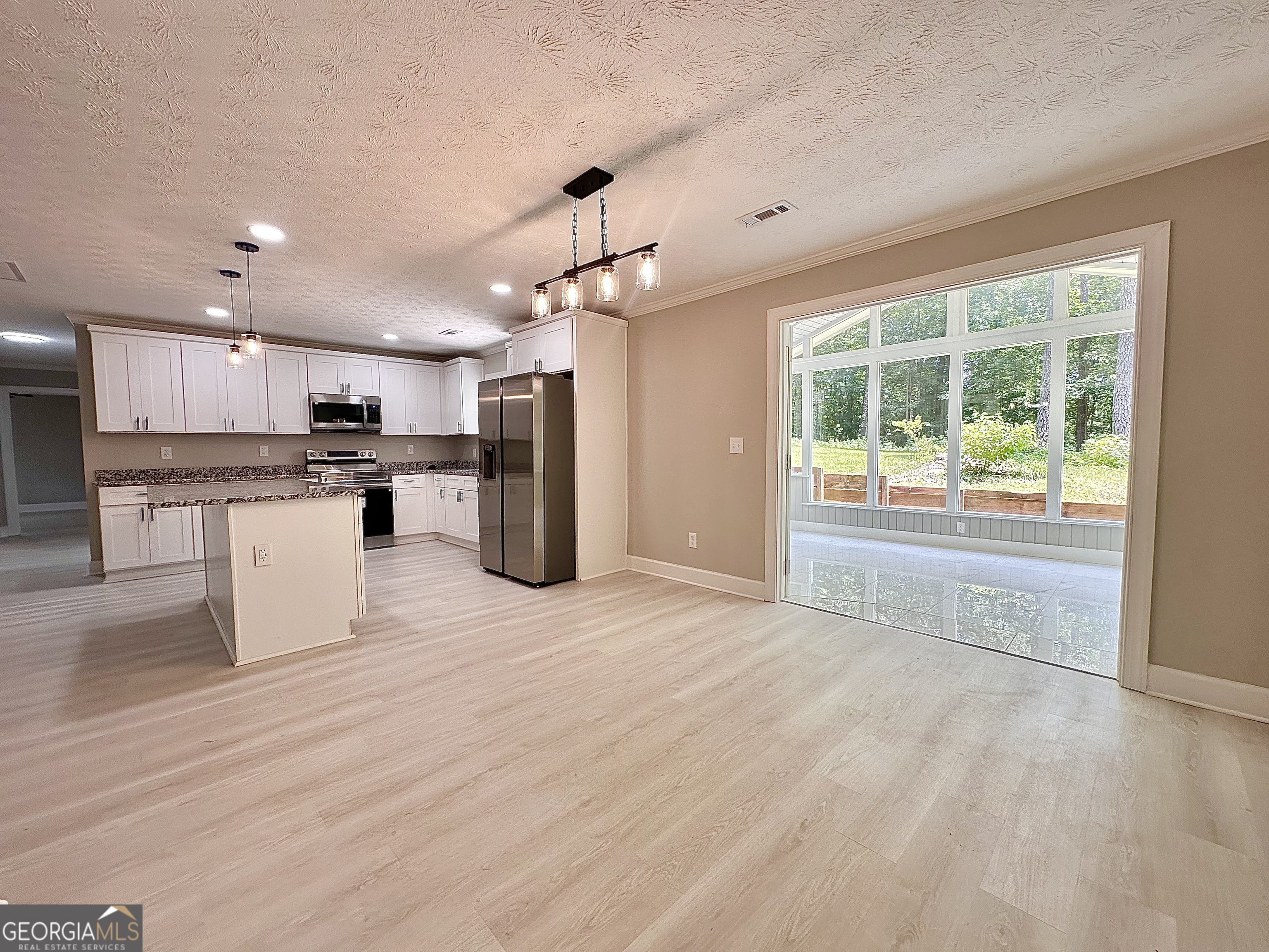 115 Creekside Lane Covington, GA 30016 - Photo 42 of 59 a view of a kitchen with a sink stainless steel appliances and cabinets