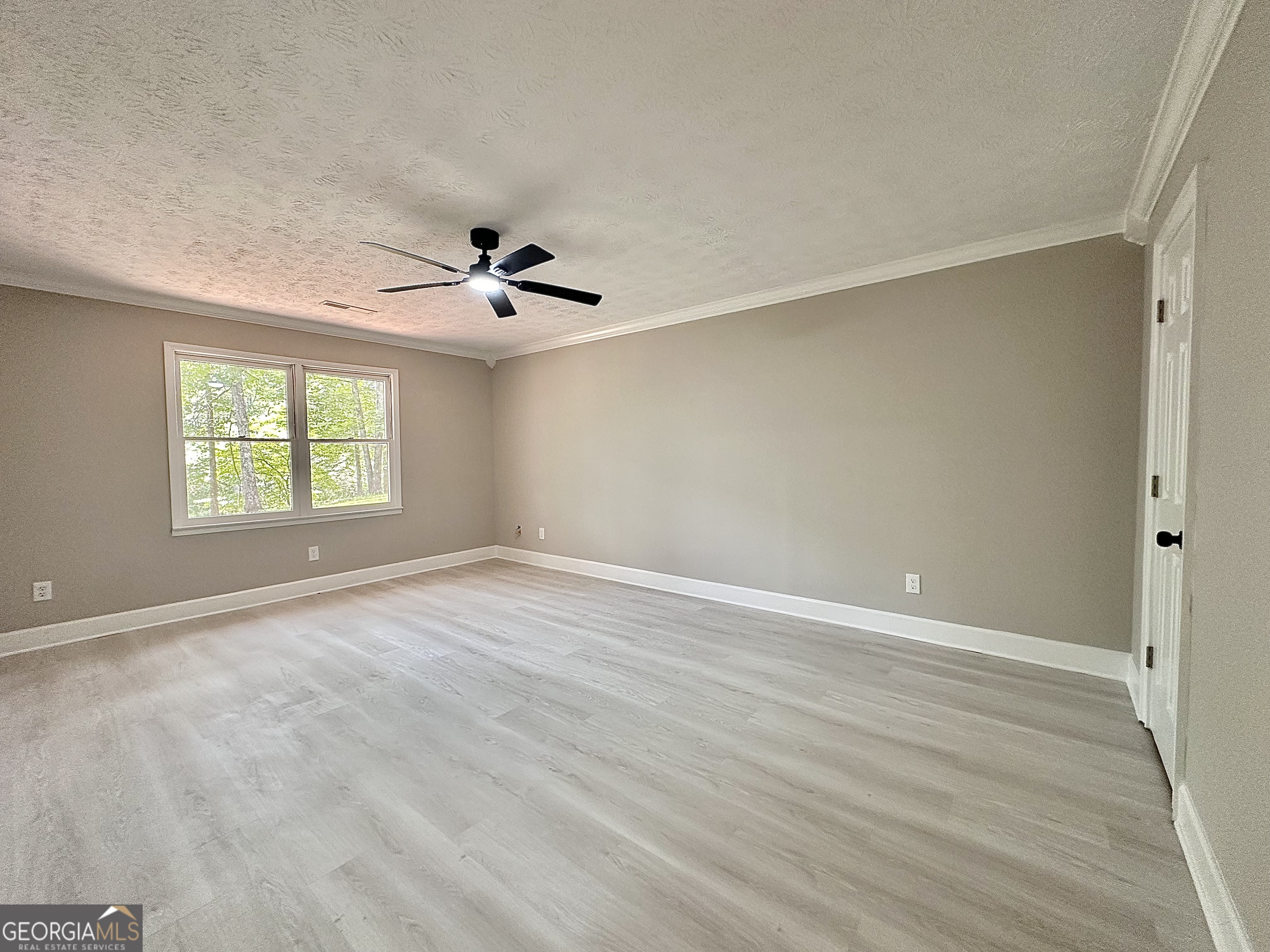 115 Creekside Lane Covington, GA 30016 - Photo 47 of 59 wooden floor in an empty room with a window