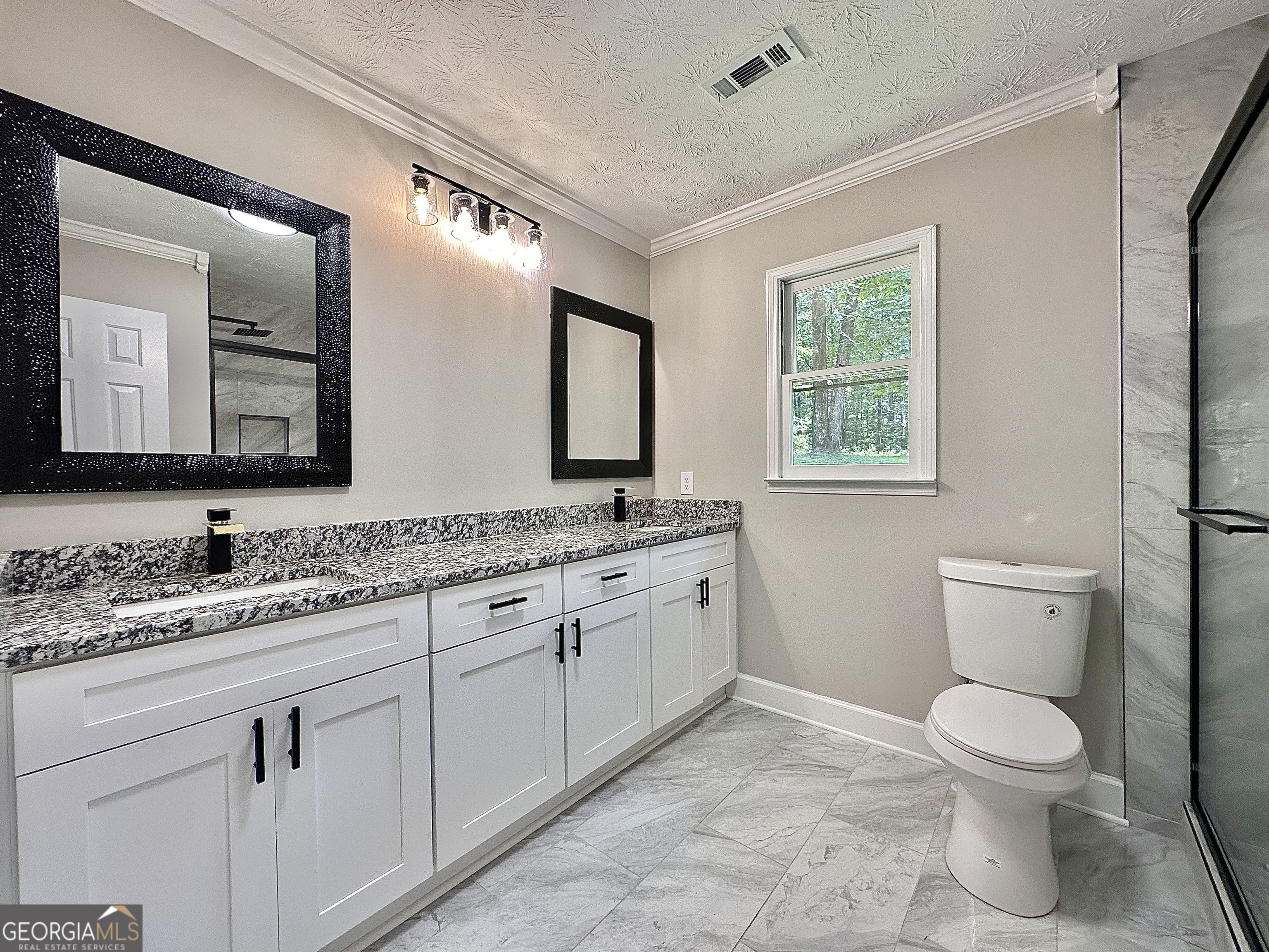 115 Creekside Lane Covington, GA 30016 - Photo 50 of 59 a bathroom with a toilet sink and mirror