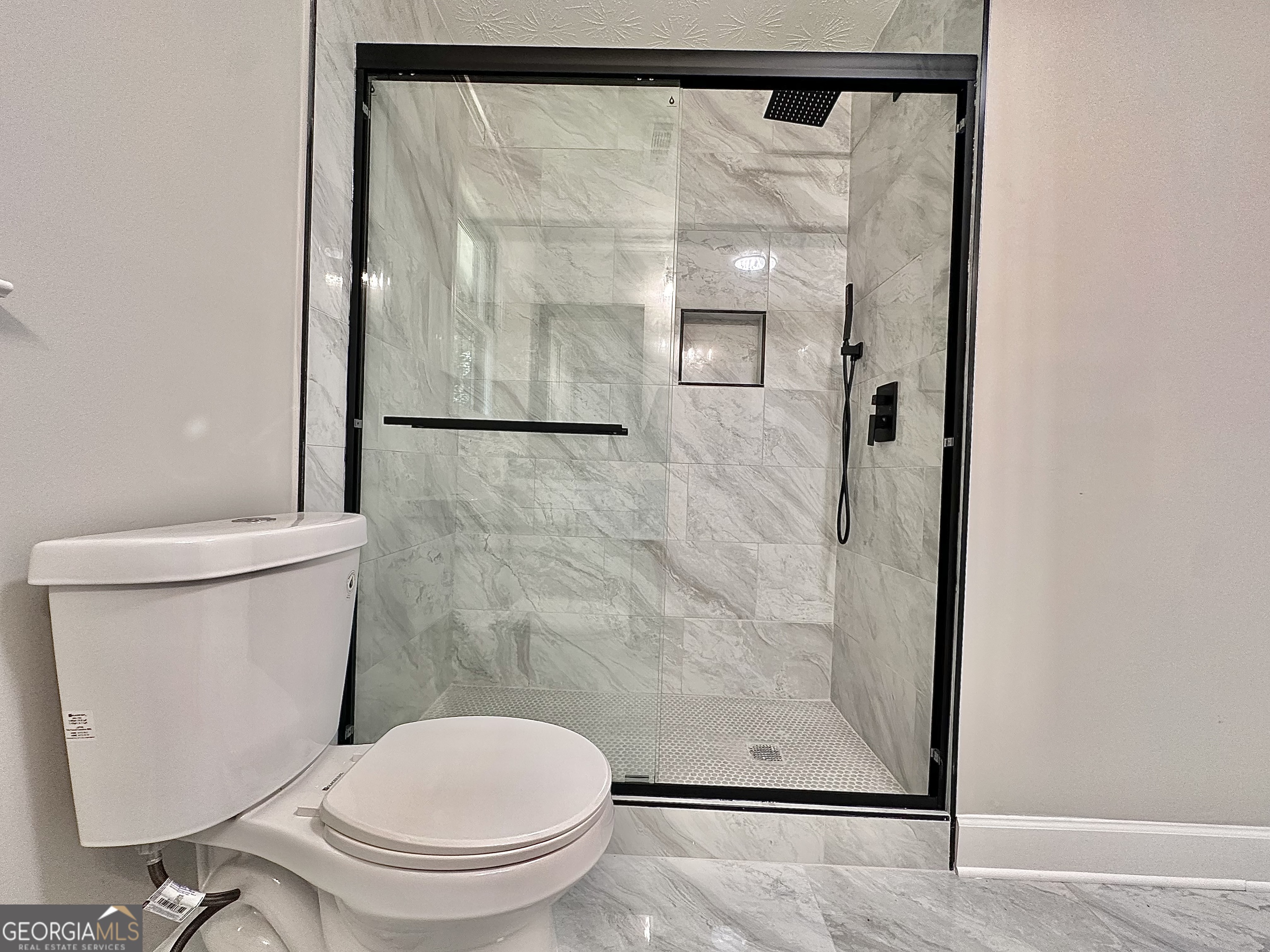 115 Creekside Lane Covington, GA 30016 - Photo 53 of 59 a white toilet sitting next to a bathroom sink