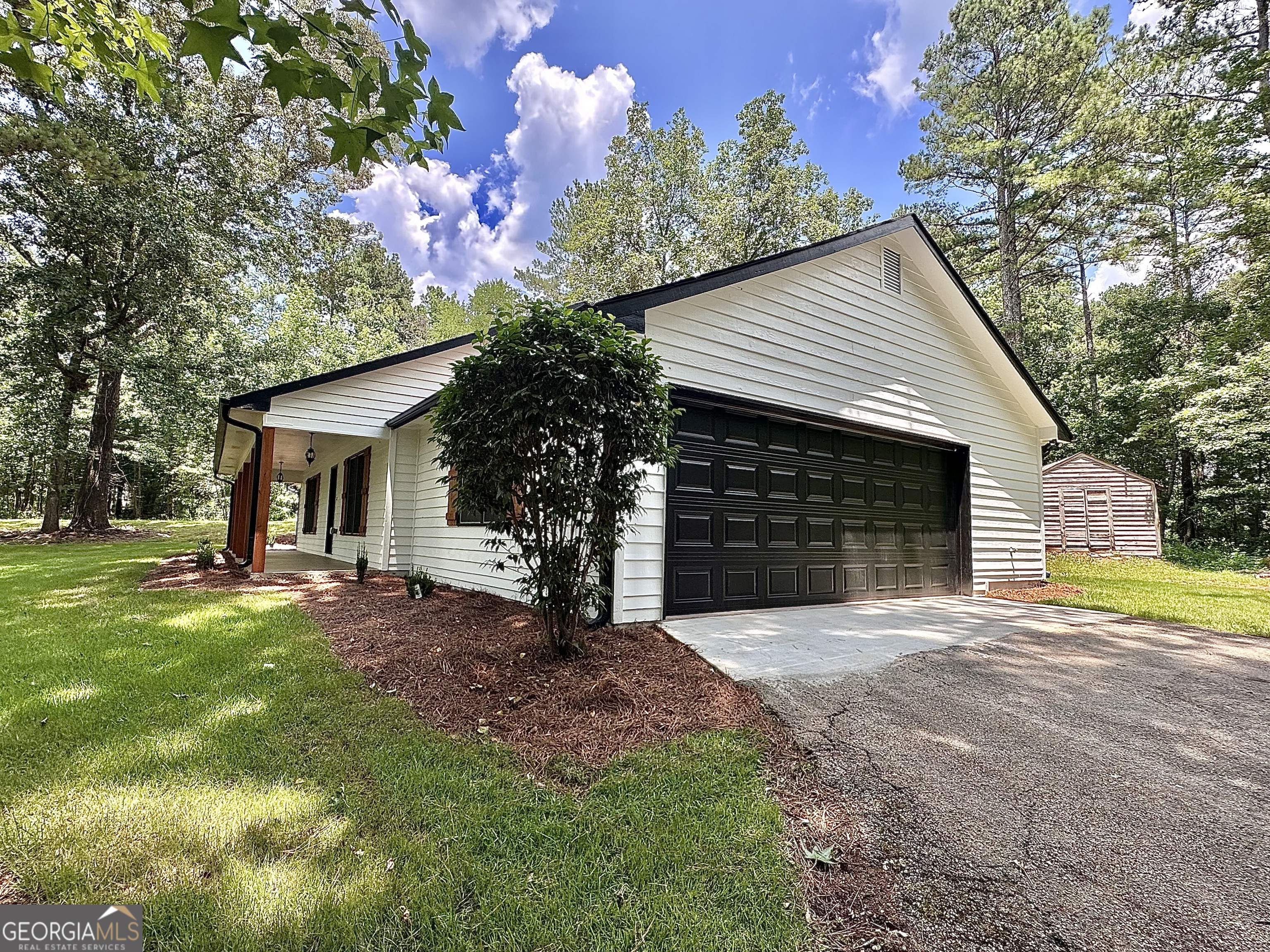 115 Creekside Lane Covington, GA 30016 - Photo 8 of 59 a front view of a house with a yard and garage