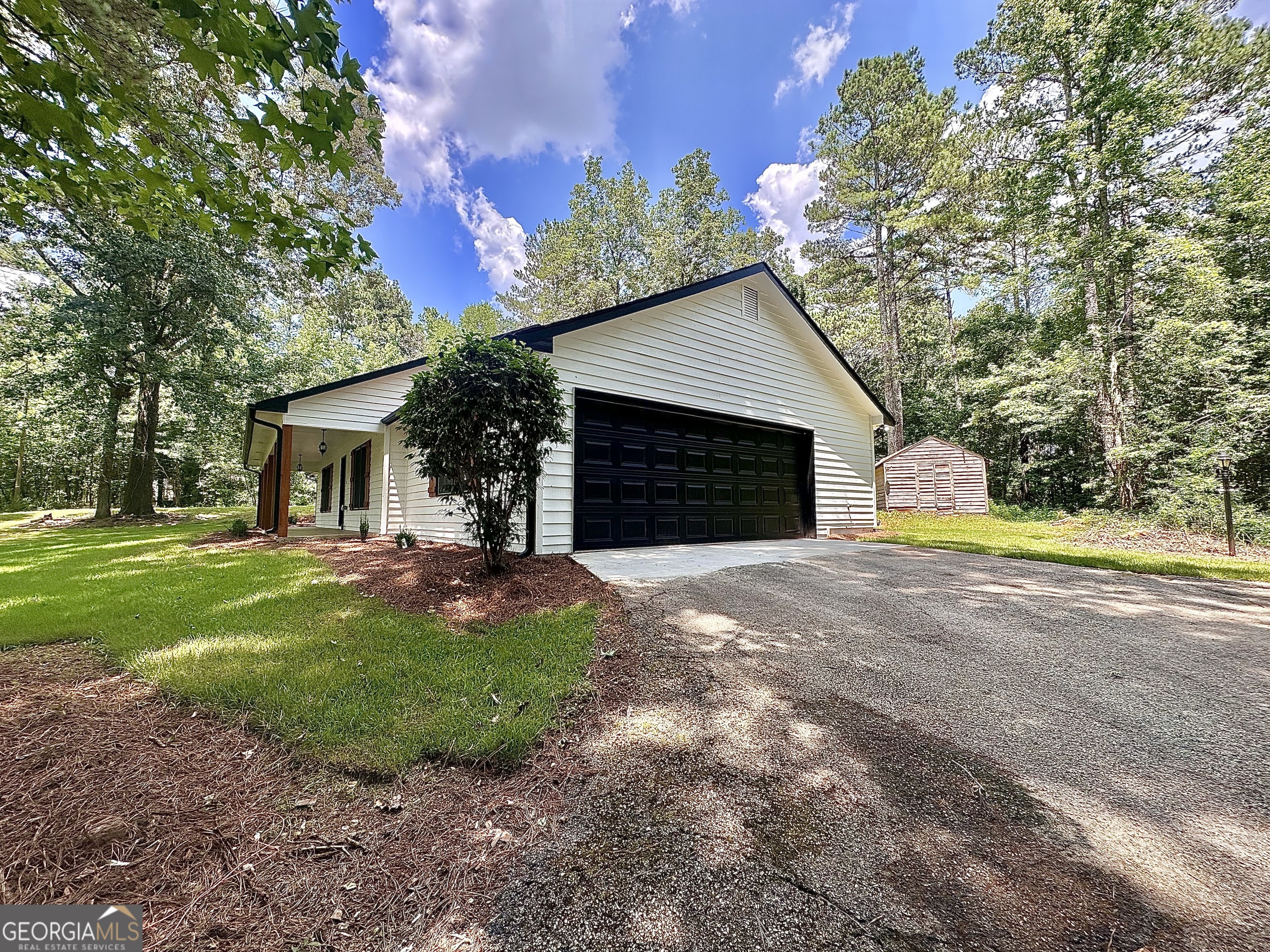115 Creekside Lane Covington, GA 30016 - Photo 9 of 59 a view of a house with a yard and large tree