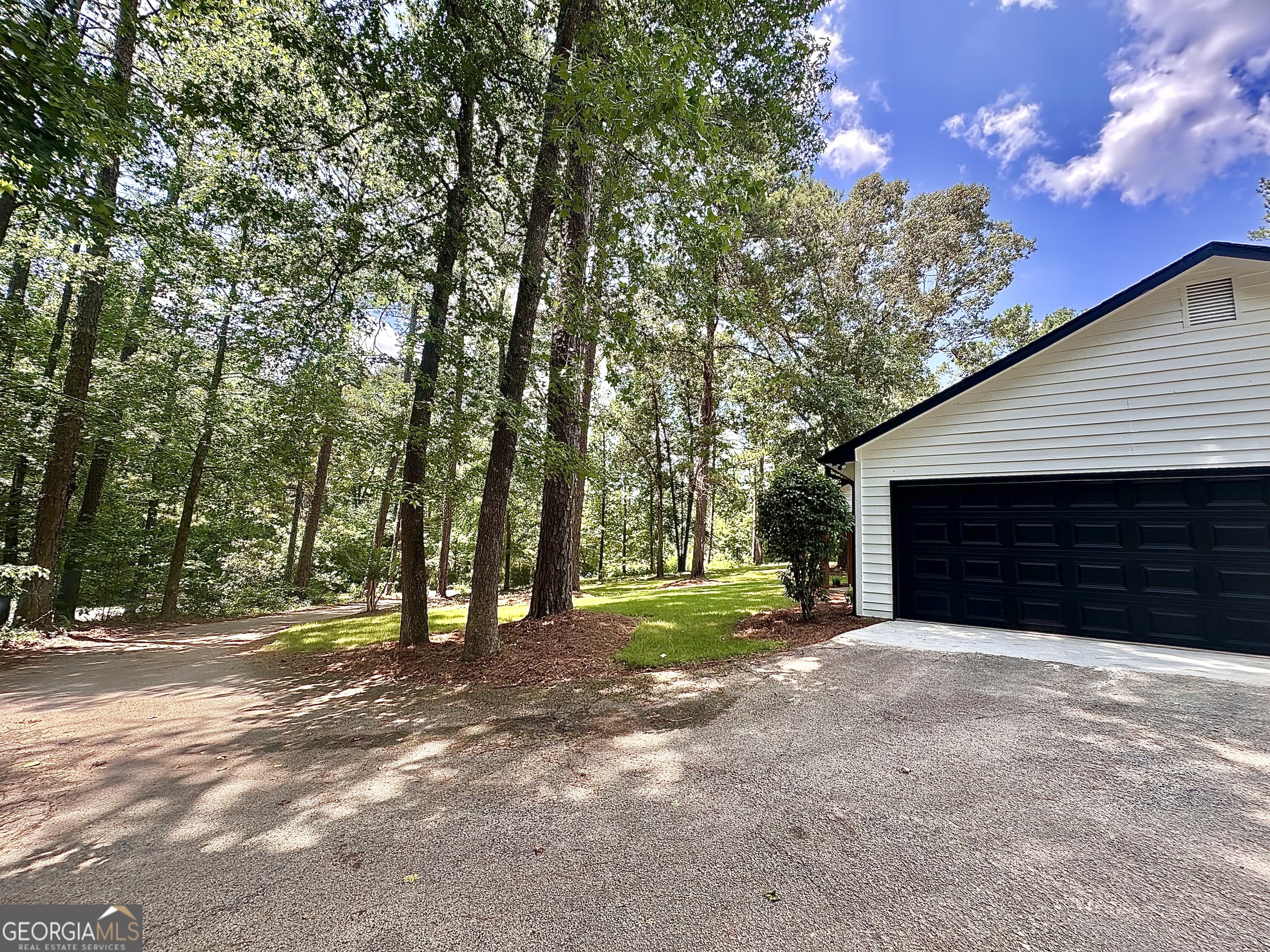 115 Creekside Lane Covington, GA 30016 - Photo 10 of 59 a view of a house with large trees and a small yard