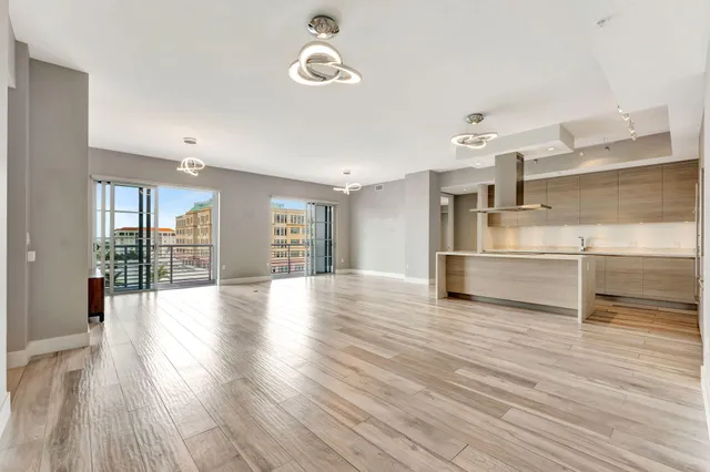 a kitchen with stainless steel appliances granite countertop a sink and dishwasher a stove with wooden floors