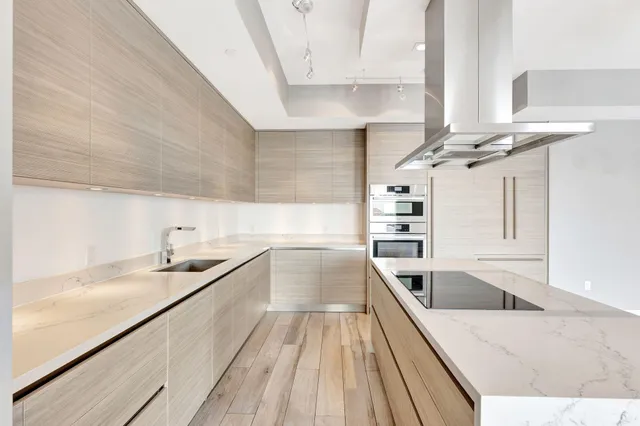 a view of a hallway with closet and wooden floor