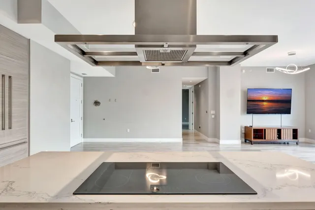 a bedroom with a large bed a potted plant and a window