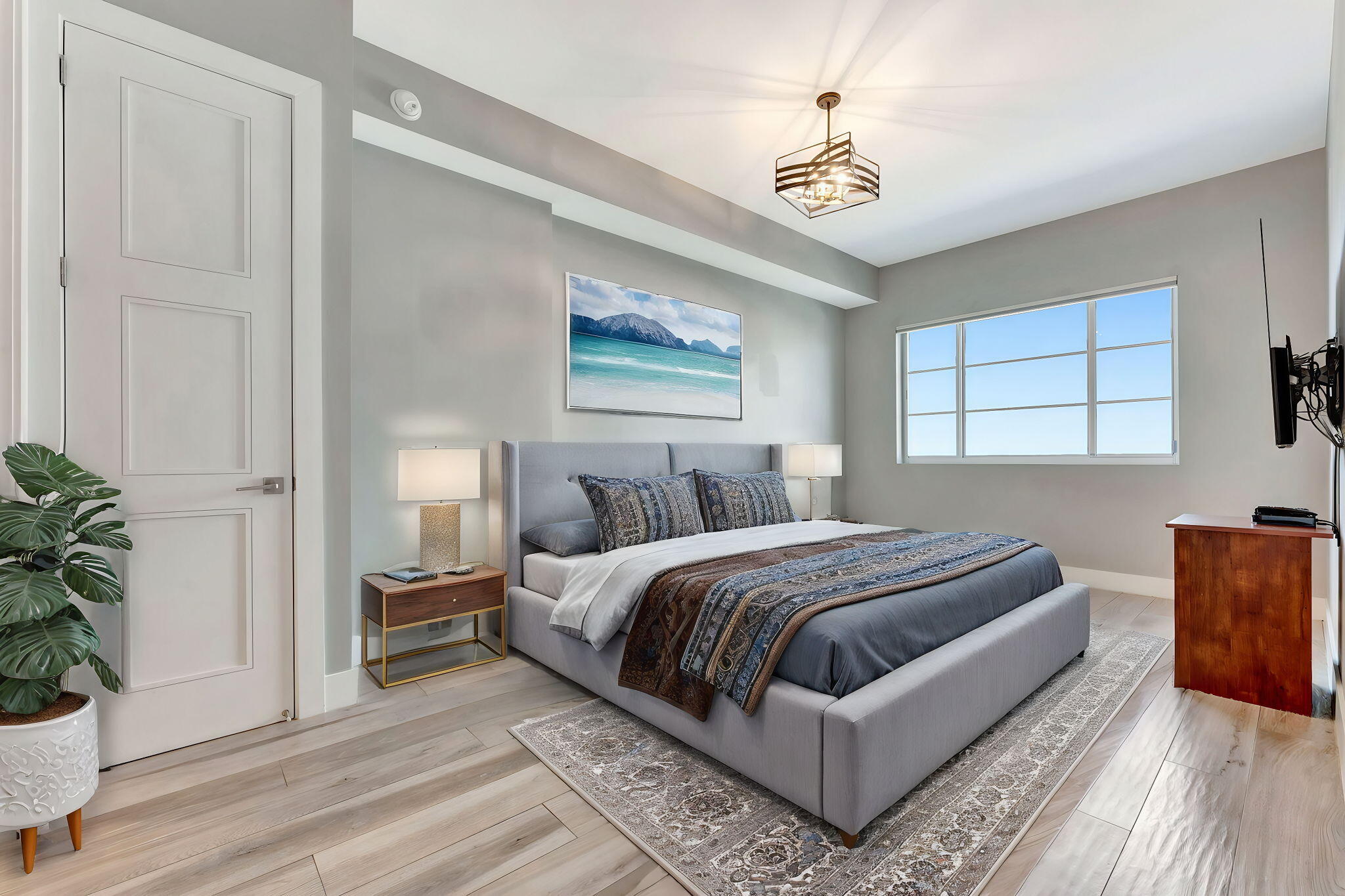 155 East Boca Raton Road, Unit 719 Boca Raton, FL 33432 - Photo 38 of 102 a bedroom with a large bed a potted plant and a window