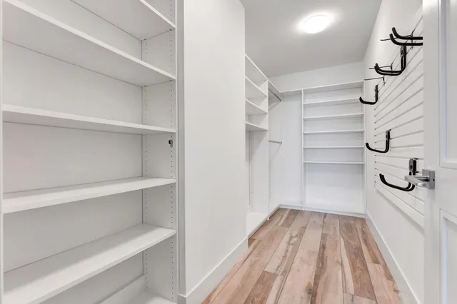 a view of a patio with couches table and chairs potted plants and palm trees
