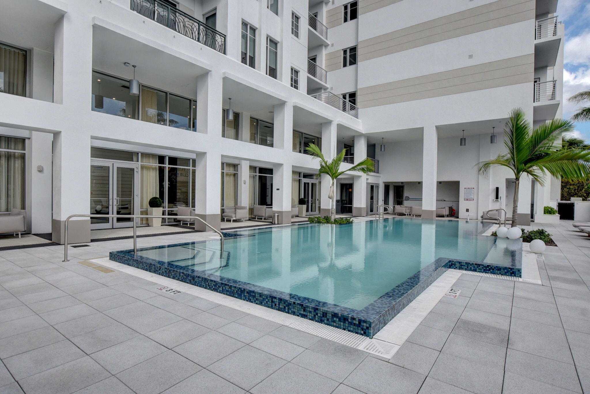 155 East Boca Raton Road, Unit 719 Boca Raton, FL 33432 - Photo 68 of 102 a view of a swimming pool with a patio