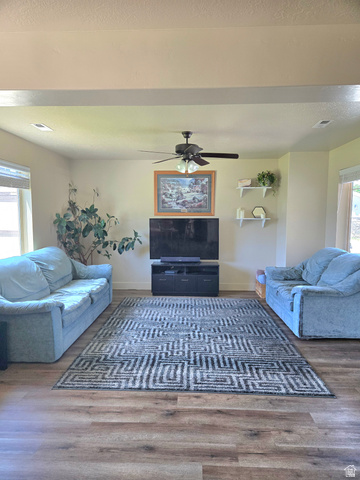 601 West 150 North, Unit 25 Springville, UT 84663 - Photo 2 of 29 Open-concept living space featuring wood-finish flooring, recessed lighting, a ceiling fan, and large windows providing natural illumination