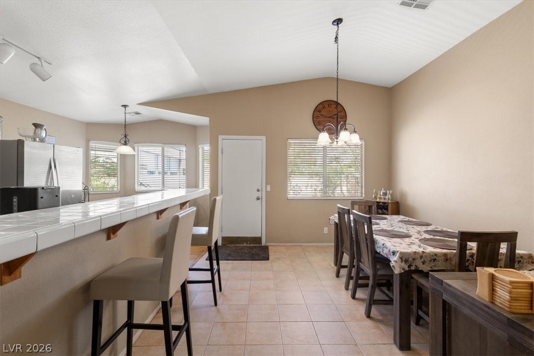 2377 Ramsgate Drive Henderson, NV 89074 - Photo 7 of 25 Functional kitchen with convenient bar seating and dining area for seamless entertaining.