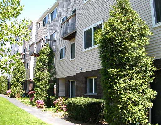 10 Fort Point Street, Unit A7 Norwalk, CT 06855 - Photo 1 of 1 a front view of a house with a garden