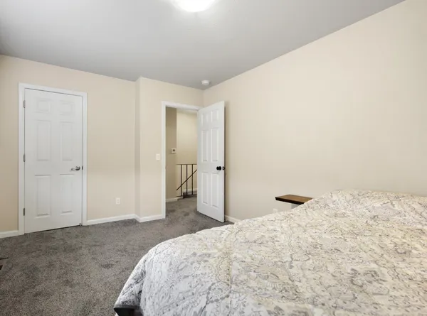 a bedroom with a bed and a view of bathroom