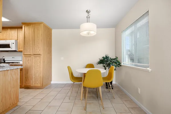a view of a dining room with furniture and a chandelier