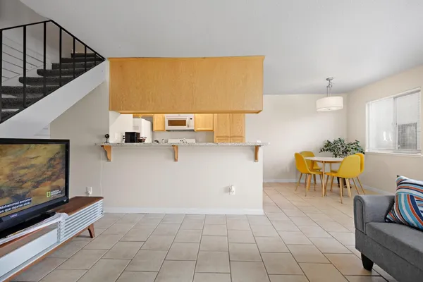 a view of kitchen with furniture and electronic appliances