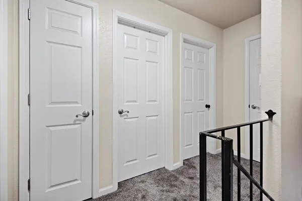 a view of a hallway with wooden floor and entryway