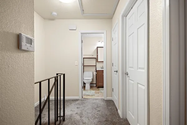 a view of a hallway with wooden shelves