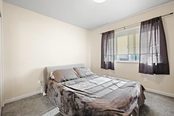 a bedroom with a bed and window