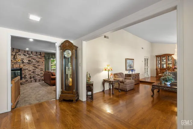 a living room with furniture pool and wooden floor