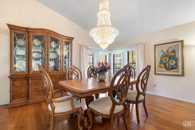 a view of a dining room with furniture wooden floor and chandelier