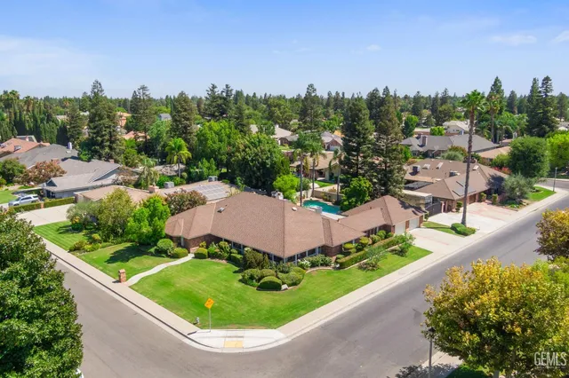 an aerial view of a house with garden space and street view