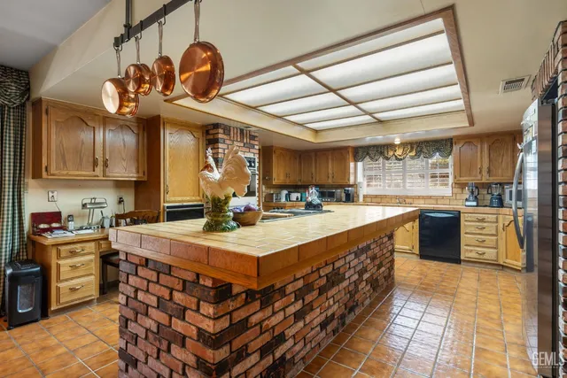 a kitchen with a stove a sink and a refrigerator