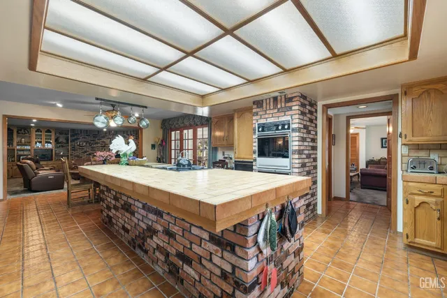 a living room with furniture two window and a flat screen tv