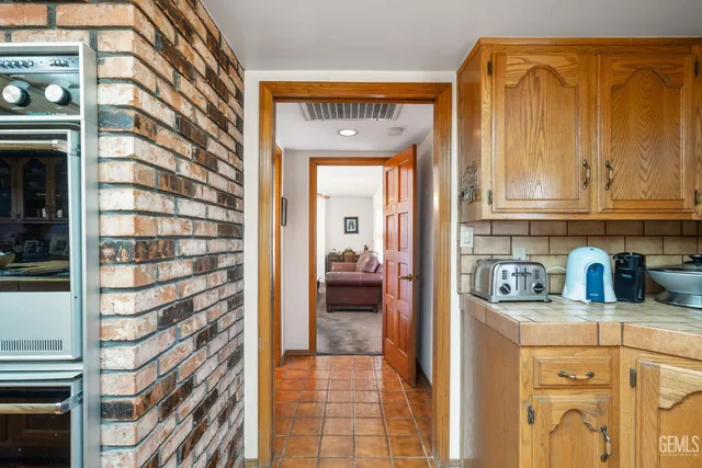 a living room with furniture a air conditioner vent and a window