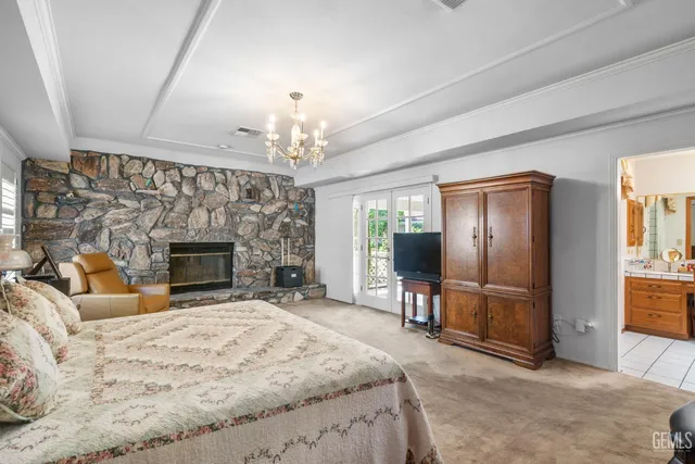 a bedroom with a bed flat screen tv and dresser