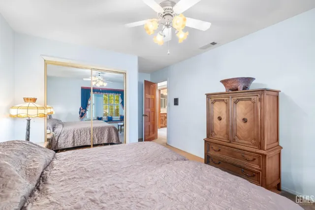 a living room with furniture a ceiling fan and a window