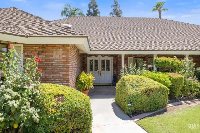a front view of a house with garden