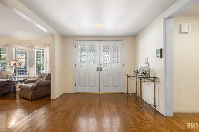 a view of a livingroom with furniture wooden floor and windows